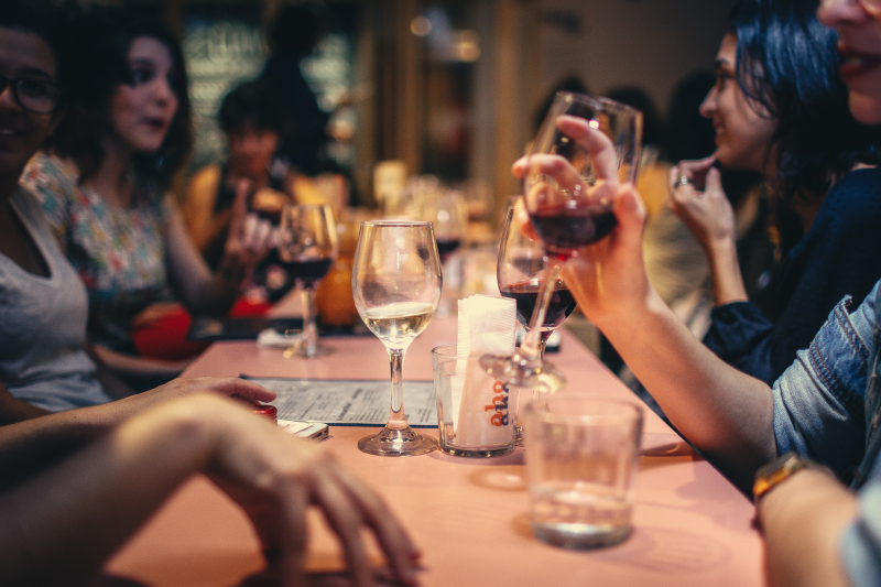 People-drinking-liquor-and-talking-on-dining-table-close-up-696218